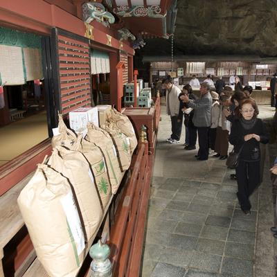 The main shrine with bags of rice and sake lined up as offerings.