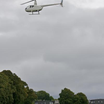 A helicopter makes an emergency stop off at someones house.